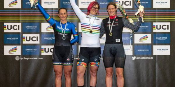 Canadian cyclist Rachel McKinnon (C) celebrates her gold medal on the podium with bronze medalist Kirsten Herup Sovang (R) of Denmark and silver medalist Dawn Orwick (L) of the USA, for the F35-39 Sprint discipline of the UCI Masters Track Cycling World Championships, in Manchester on October 19, 2019. - Transgender cyclist Rachel McKinnon has defended her right to compete in women's sport despite accepting trans athletes may retain a physical advantage over their rivals. (Photo by OLI SCARFF / AFP)