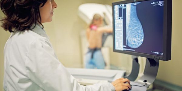 Doctor is working with mammography X-ray scanner in hospital