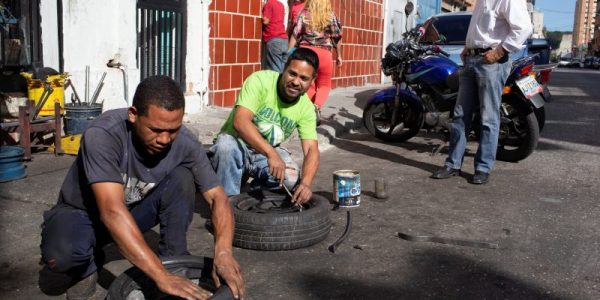 Workers repair tires at a workshop in Caracas, Venezuela December 10, 2018. REUTERS/Manaure Quintero